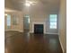 Spacious living room featuring gleaming dark wood floors, a fireplace, and an open layout at 687 Ponderosa Dr, Charleston, SC 29414