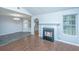 Spacious area with gas fireplace, hardwood flooring, and large windows at 687 Ponderosa Dr, Charleston, SC 29414