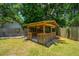 Pergola offers shaded backyard seating with a view of the green lawn and house at 687 Ponderosa Dr, Charleston, SC 29414