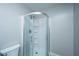 Bathroom with modern curved glass shower and white toilet at 687 Ponderosa Dr, Charleston, SC 29414