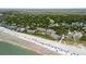 Aerial view of the community buildings with a beach, trees, a swimming pool, and umbrellas at 7 Beach Club Villas, Isle of Palms, SC 29451