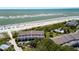 Aerial view of the community buildings with a beach, trees, a pool, and umbrellas at 7 Beach Club Villas, Isle of Palms, SC 29451