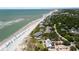 Aerial view of the community buildings with a beach, trees, a building with an outdoor area, and umbrellas at 7 Beach Club Villas, Isle of Palms, SC 29451