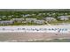 Aerial view of the community buildings with a beach, trees, and umbrellas at 7 Beach Club Villas, Isle of Palms, SC 29451