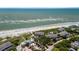 Aerial view of community buildings near the ocean, along with a beach, and umbrellas at 7 Beach Club Villas, Isle of Palms, SC 29451