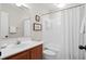 A bathroom featuring a white shower curtain and a wooden vanity at 7 Beach Club Villas, Isle of Palms, SC 29451