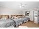 Bedroom featuring three twin beds with gray comforters and woven headboards at 7 Beach Club Villas, Isle of Palms, SC 29451