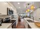 Open concept kitchen with island and stainless appliances leads to living and dining area at 7 Beach Club Villas, Isle of Palms, SC 29451