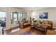 Bright living room with comfortable seating, stylish rug, and sliding doors to a balcony with an ocean view at 7 Beach Club Villas, Isle of Palms, SC 29451