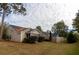 A grassy backyard is framed by a wooden fence and mature trees, offering privacy and space for outdoor activities at 7322 Stoney Moss Way, Hanahan, SC 29410