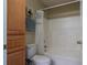 Clean bathroom showcasing a built-in linen closet and shower-tub combo at 7322 Stoney Moss Way, Hanahan, SC 29410