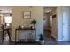 Inviting hallway featuring a console table and views into the kitchen and living areas at 7322 Stoney Moss Way, Hanahan, SC 29410