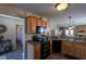 Open kitchen with plentiful wooden cabinets, modern appliances, and seamless access to other living areas at 7322 Stoney Moss Way, Hanahan, SC 29410