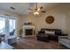 Comfortable living room featuring a fireplace, ceiling fan, and access to the patio at 7322 Stoney Moss Way, Hanahan, SC 29410