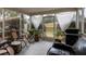 A screened porch features comfortable seating, plants, and a grill, perfect for outdoor relaxation and entertaining at 7322 Stoney Moss Way, Hanahan, SC 29410