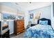 Bright bedroom with blue walls, two windows, and a comfortable bed with nautical themed bedding at 7897 Russell Creek Dr, Edisto Island, SC 29438