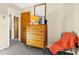 Bedroom with a classic wooden dresser, vintage television, and access to hallway at 7897 Russell Creek Dr, Edisto Island, SC 29438