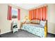 Cozy bedroom with a daybed, colorful bedding, and natural light streaming through the window at 7897 Russell Creek Dr, Edisto Island, SC 29438
