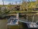 Aerial view of dock and walkway to waterfront home with mature trees at 7897 Russell Creek Dr, Edisto Island, SC 29438