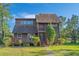 Charming exterior of a two-story home with a well-maintained lawn and landscaping at 7897 Russell Creek Dr, Edisto Island, SC 29438