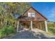 Spacious garage area with ample storage and open design, surrounded by lush greenery at 7897 Russell Creek Dr, Edisto Island, SC 29438