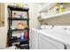 Functional laundry room featuring a washer, dryer, and shelving at 7897 Russell Creek Dr, Edisto Island, SC 29438