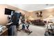 Carpeted bonus room with a home gym, mounted TV, and comfortable seating area, perfect for relaxation and entertainment at 8475 N Scotts Mill Dr, North Charleston, SC 29420