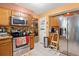 Kitchen with stainless steel appliances, wooden cabinets, tile floors and access to dining room at 8475 N Scotts Mill Dr, North Charleston, SC 29420