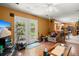 Open-concept living area boasts a TV, ceiling fan, glass panel doors and a view into kitchen at 8475 N Scotts Mill Dr, North Charleston, SC 29420