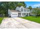 Two-story home with a well-manicured lawn, a driveway, and a two-car garage at 8475 Scotts Mill Dr North, North Charleston, SC 29420