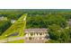 Aerial view showcasing townhomes, lush greenery, a pond, and a community setting at 854 Bibury Ct, Charleston, SC 29414