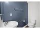 Powder room featuring vanity sink, toilet, and modern fixtures on a dark blue accent wall at 854 Bibury Ct, Charleston, SC 29414
