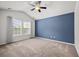 Spacious bedroom with blue accent wall, ceiling fan, and large windows providing natural light at 854 Bibury Ct, Charleston, SC 29414