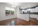Bright dining area featuring hardwood floors, chandelier lighting, and an adjacent kitchen with granite countertops at 854 Bibury Ct, Charleston, SC 29414