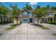 Charming townhomes with stone accents, vibrant doors, and well-manicured front yards and driveways at 854 Bibury Ct, Charleston, SC 29414