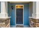 Close up of townhome door with stone accents, blue siding, and a 'hello' welcome mat at 854 Bibury Ct, Charleston, SC 29414