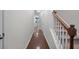 Hallway featuring hardwood floors leading to the kitchen area with a staircase on the right at 854 Bibury Ct, Charleston, SC 29414