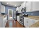 Kitchen featuring stainless steel appliances, granite countertops, and white cabinets at 854 Bibury Ct, Charleston, SC 29414