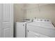 Laundry room featuring modern white appliances and wire shelving at 854 Bibury Ct, Charleston, SC 29414