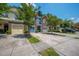 Inviting street view features colorful townhomes with garages and flowering trees, creating a welcoming and picturesque neighborhood ambiance at 854 Bibury Ct, Charleston, SC 29414