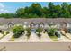 A serene view of colorful townhomes complemented by lush trees and well-maintained landscaping, creating a welcoming neighborhood scene at 854 Bibury Ct, Charleston, SC 29414