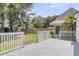 Inviting back deck with white railings, offering serene views of the backyard and mature trees at 9253 N Moreto Cir, Summerville, SC 29485