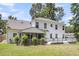 Spacious backyard showcasing a well-maintained lawn, white exterior, a screened-in porch, and wooden deck at 9253 N Moreto Cir, Summerville, SC 29485