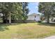 Spacious, fenced backyard with lush lawn and mature trees, perfect for outdoor activities and privacy at 9253 N Moreto Cir, Summerville, SC 29485