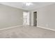 Spacious carpeted bedroom with ceiling fan, adjoining closet, and open door to the upper level at 9253 N Moreto Cir, Summerville, SC 29485