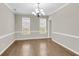 Elegant dining room with hardwood floors, chair rail molding, and stylish chandelier at 9253 N Moreto Cir, Summerville, SC 29485