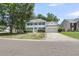 Charming two-story home with green shutters, attached garage, and meticulously manicured front yard at 9253 N Moreto Cir, Summerville, SC 29485