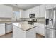 Modern kitchen with white cabinets, stainless steel appliances, and island with granite countertop at 9253 N Moreto Cir, Summerville, SC 29485