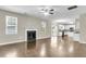 Spacious living room with fireplace, hardwood floors, and open layout to the kitchen and dining area at 9253 N Moreto Cir, Summerville, SC 29485