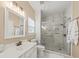 This bathroom has a glass enclosed shower and a white vanity with marble-look countertops at 9616 Pebble Creek Blvd, Summerville, SC 29485